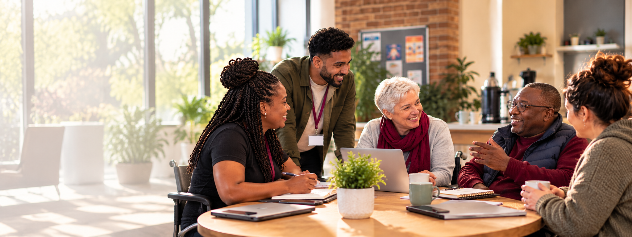 A diverse support team meeting together in a bright community space